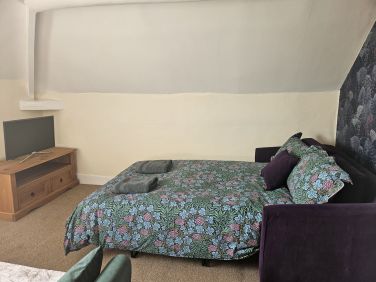 Sofas in the snug area of Drift away den, one which converts to a small double with comfy mattres