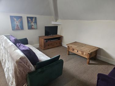 The cosy snug area in 'Drift away Den' with 2 sofas and a 32 inch smart TV