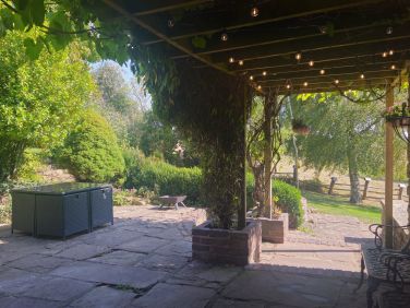 Festoon lighting and archway by the hot tub