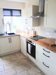 Fully equipped kitchen with dishwasher, oven, hob, microwave and washing machine.