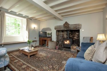 Farmhouse, Downstairs - living room w/ piano and wood burning stove