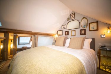 King size bed on the mezzanine level with its own flat screen wall TV