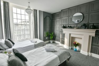 Stylish first floor bedroom with two single beds and en-suite