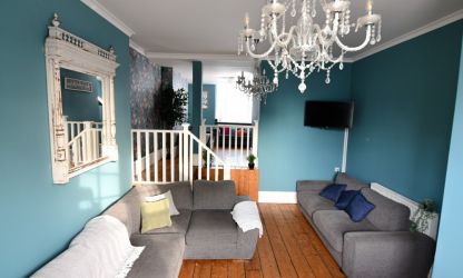 Split-level living room with lots of seating and Large TV
