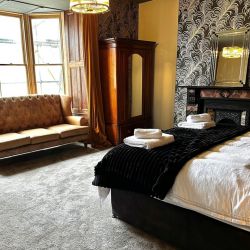 Black Feather room super-king bed over looking mountains