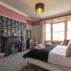 Giraffe Room, super king bed over looking Barmouth Beach