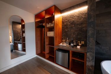 Bedroom 1. Compact storage and a stocked mini bar, teas, coffees and treats.