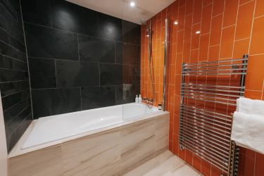 Bedroom 2. A deep, deep bath.