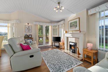 Spacious lounge/dining area with reclining sofas and views of the River Avon