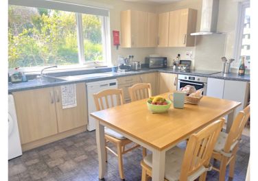 Well equipped dining kitchen alongside garden room