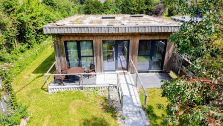 Its a modern house with a sedum roof. Bright with South Facing Windows