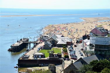View looking west from Aberdovey Hillside Village toward jetty wharf and sandy beach