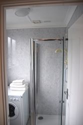 Shower room with washer/tumbler.