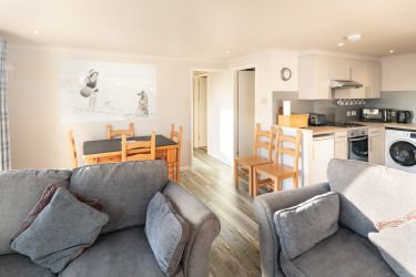 Open-plan lounge-diner, leading to well-equipped kitchen, with hallway to bedrooms and bathrooms