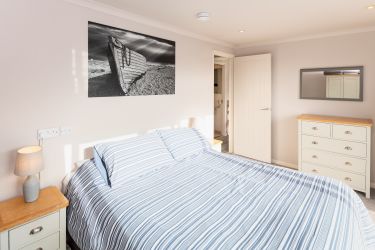 Master bedroom (sleeps 2) with double bed and beach-chic interior