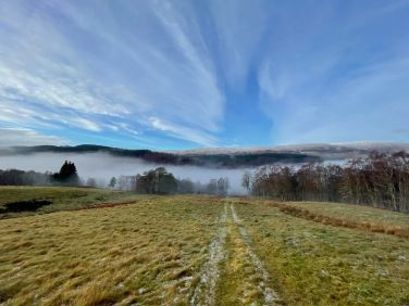 A scenic view overlooking Tomich village, captured from the hillside directly behind the cottage.