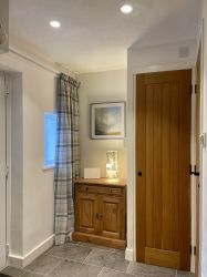 The rear hallway offers a collection of books, maps, and folders detailing various local walks.