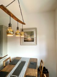 Whisky stave lighting themes the cottage, offering a subtle nod to its unique historic character.