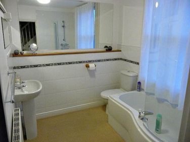 Family bathroom with shower over the bath.