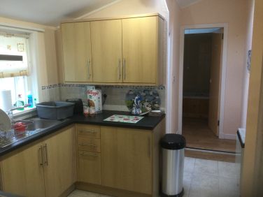 Kitchen, leading through to bathroom and utility space.