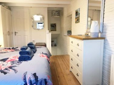 Wooden floors and ships mirror, compliment the theme.