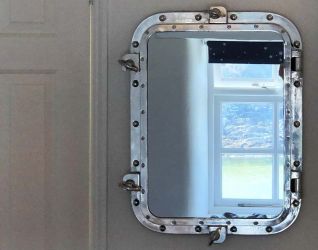 The ships mirror keeps the theme and reflects the beautiful surroundings.