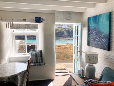 The living room opens to the sea facing patio.