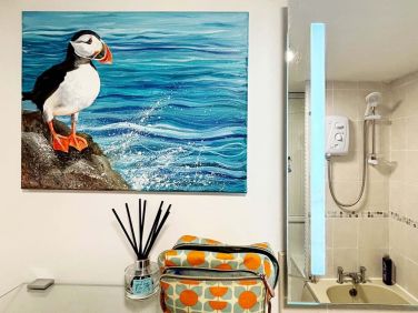 Even the bathroom has original art.