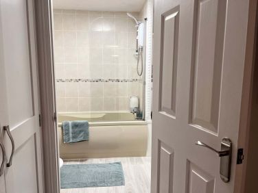 The bathroom does have a bath with the shower above.