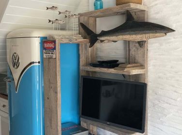 The retro Volkswagen inspired fridge freezer, with reclaimed wooden shelves.