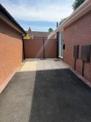 Main driveway showing entrance door and secure fencing