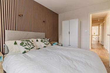 Bed 2 with double bed, wardrobe, acoustic panelling and wall lights.