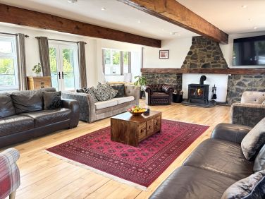 Huge living room with balcony over the pool, 65" smart TV, log burner