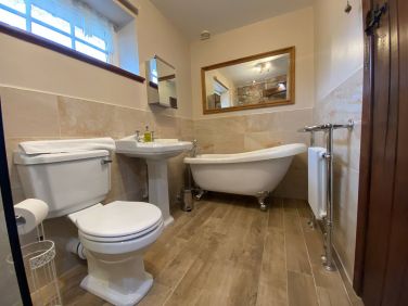 Bath and shower family bathroom with roll top bath