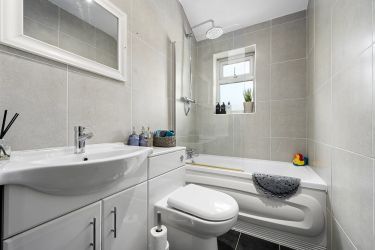 Bathroom with a waterfall shower with a 2nd lower showerhead and a 3/4 sized bath