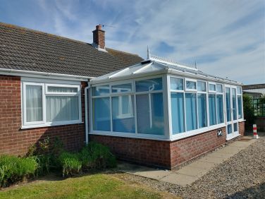 Front bedroom and conservatory look out over the fields