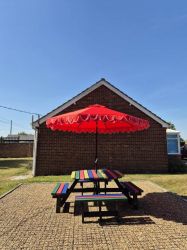 Patio picnic table to the side of Larksong