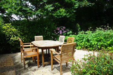 Garden with table and chairs, and sun loungers