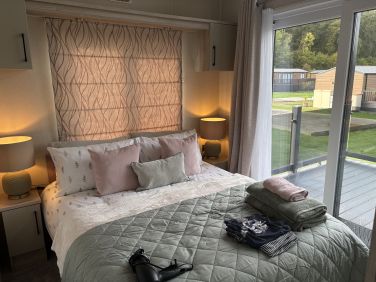 King size bed/ sliding doors to decking