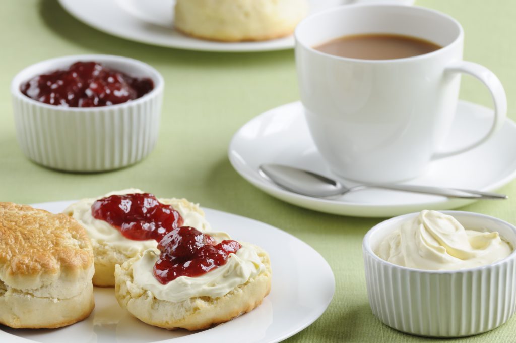 Cream tea with scones, cream, jam and a cup of tea