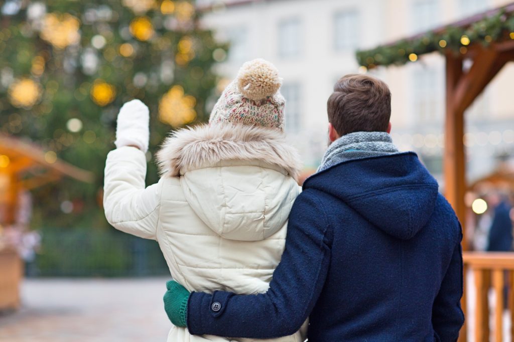 couple looking at Christmas tree outside