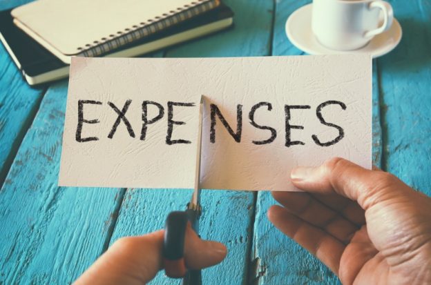 Expenses sign being cut in half