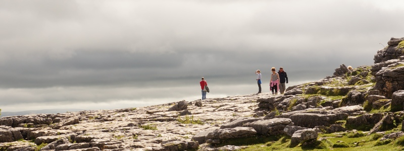 People looking off the top of Malham Cove