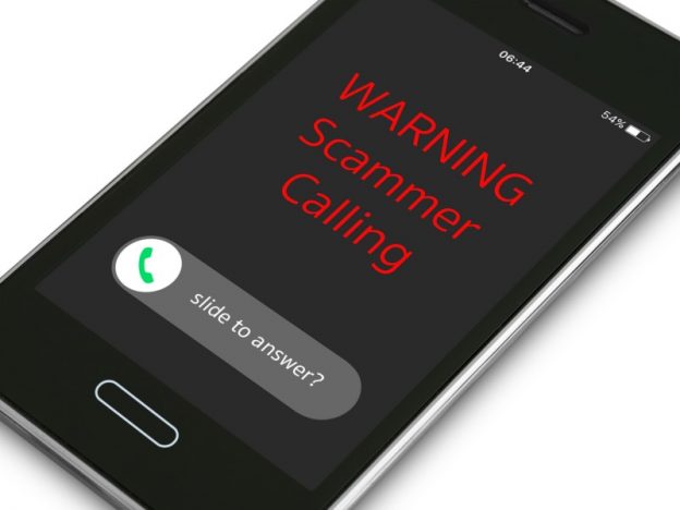 phone with 'warning scammer calling' on the screen