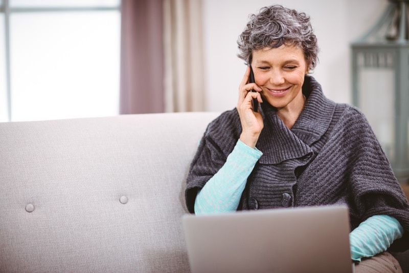 Lady on phone at laptop