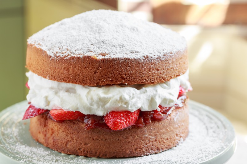 Big victoria sponge cake filled with cream and strawberries