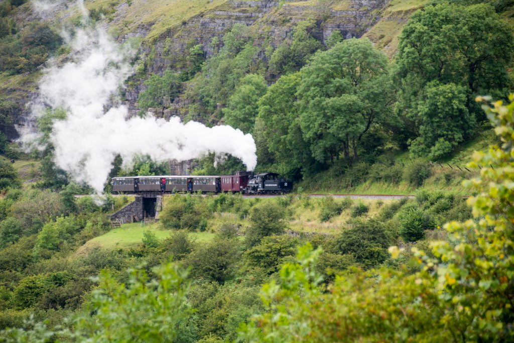 Steam train chugging through the mountains