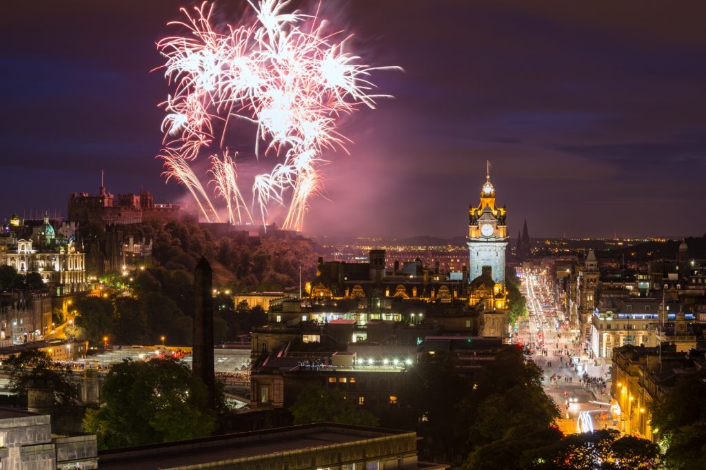 Fireworks going off in the night sky over Edinburgh Castle